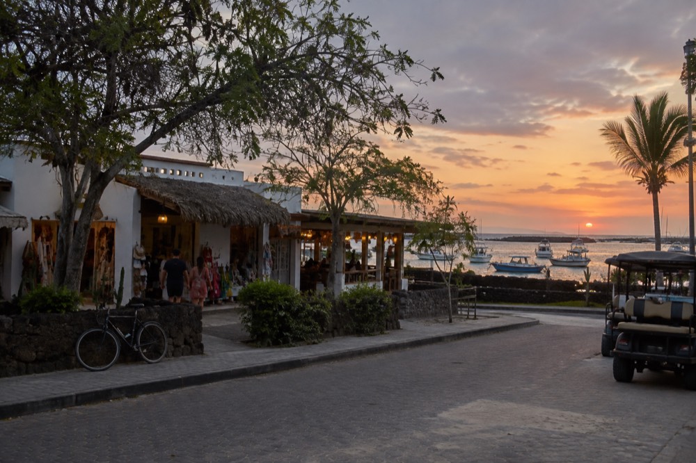 Avenida Charles Darwin in Puerto Ayora, Galapagos Islands, Ecuador, seen across the street at dusk