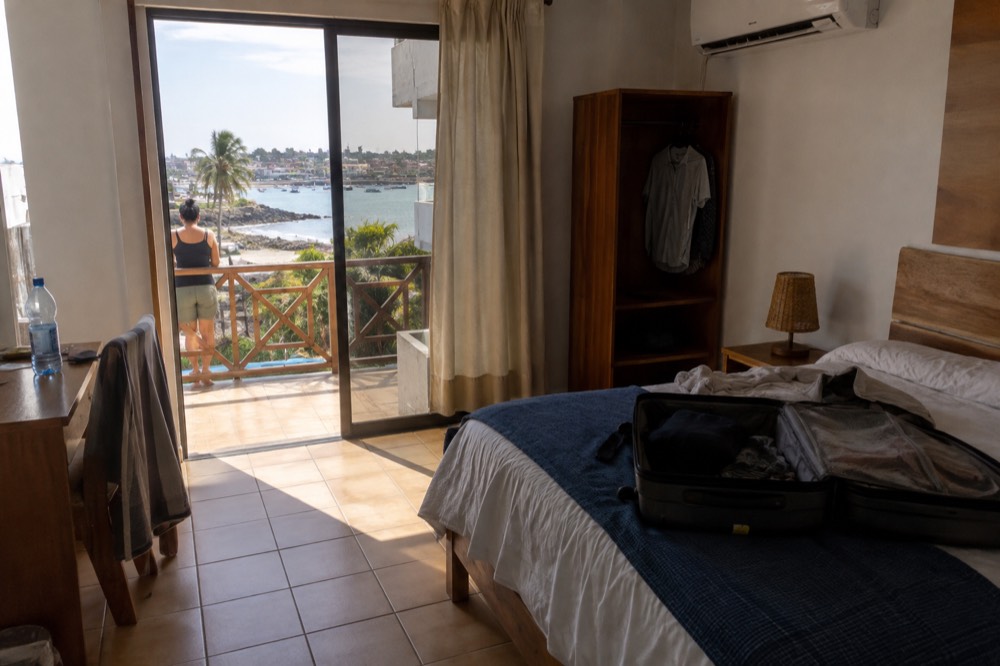 A simple mid-range hotel room in Puerto Ayora, Galapagos Islands, Ecuador: tiled floor, shipped-in particleboard furniture, air-con unit